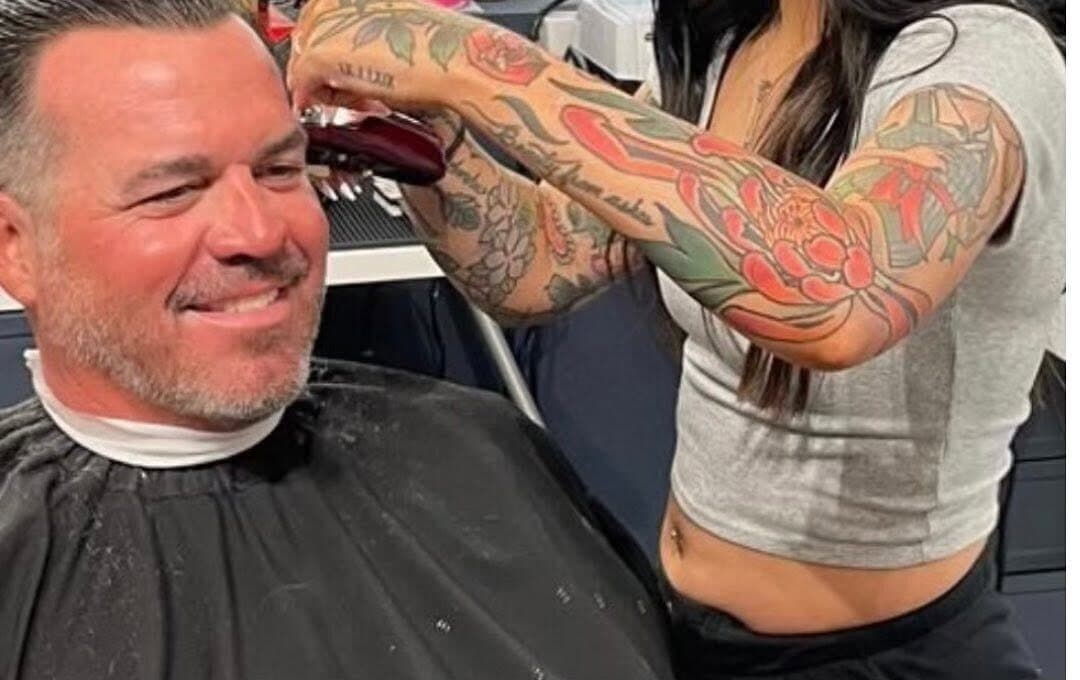 A barber at S|X Barbershop giving a client a fresh cut