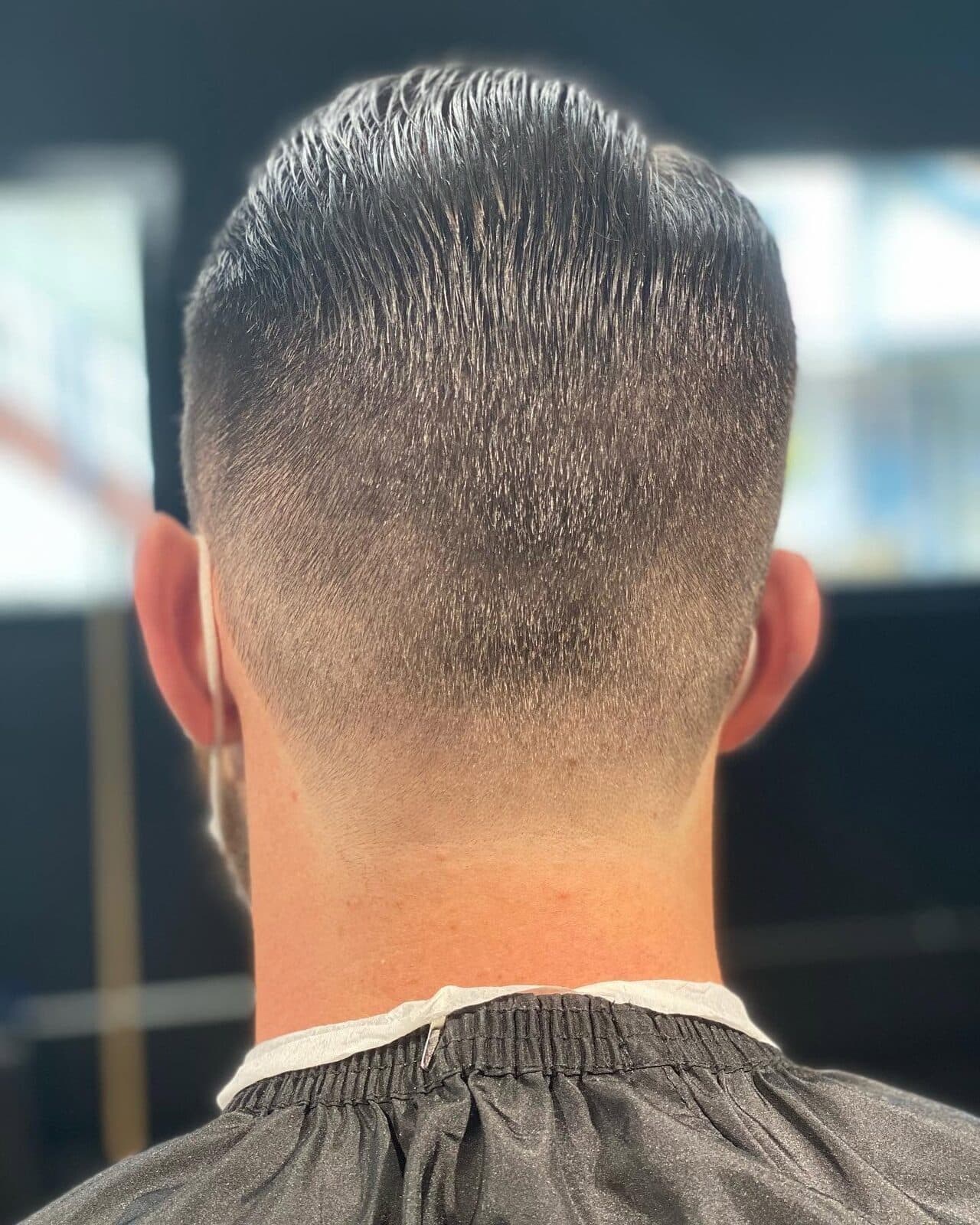 Crisp low fade with defined nape line at S|X Barbershop