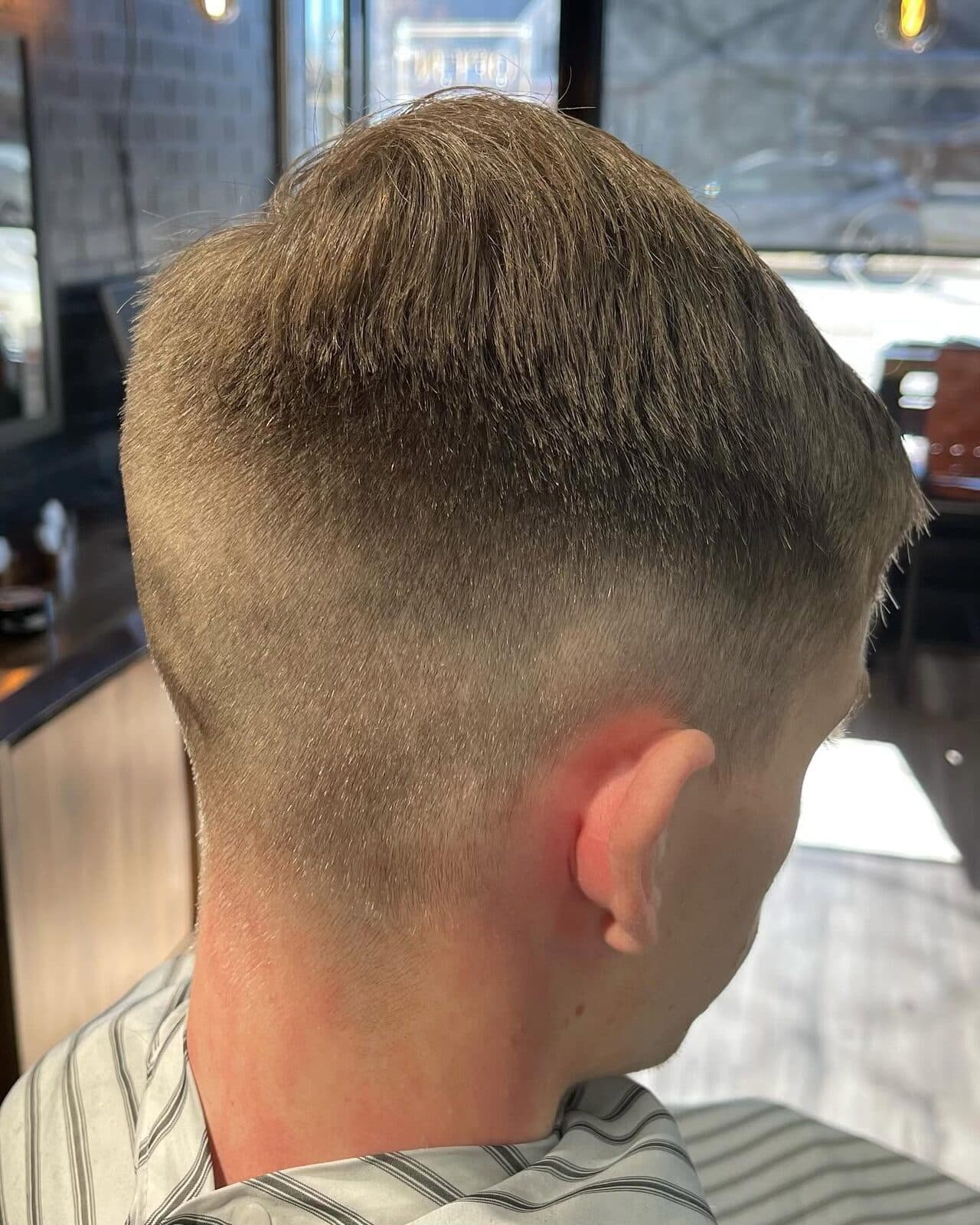 Closely cropped fade finished at S|X Barbershop